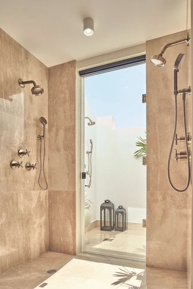 Stone-tiled indoor and outdoor showers at Cap Juluca, Anguilla.