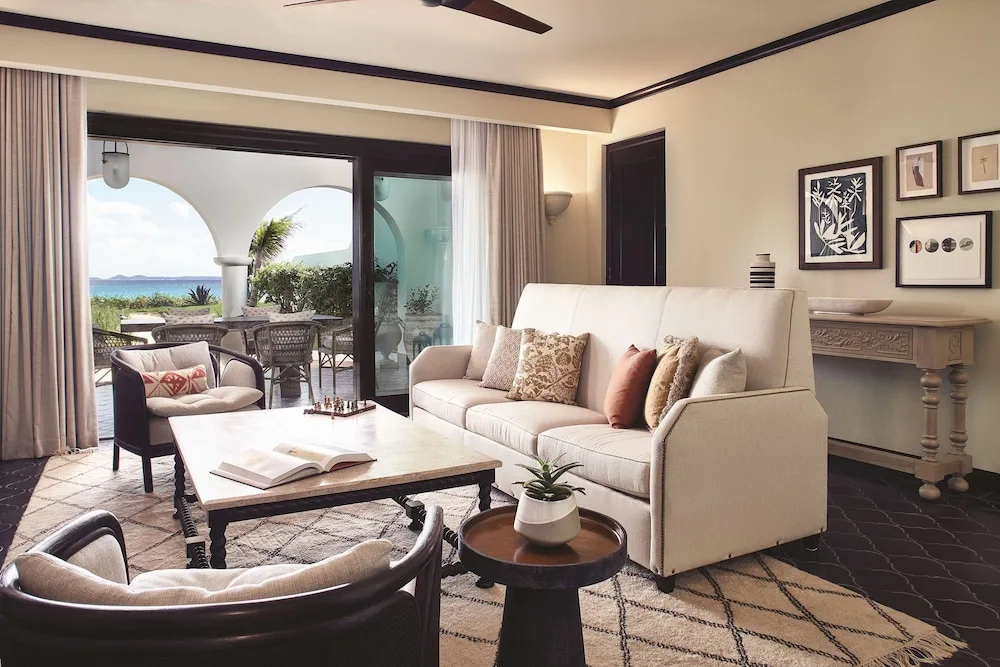 Living room with sofa, chairs, and ocean-view terrace at Cap Juluca, Anguilla.