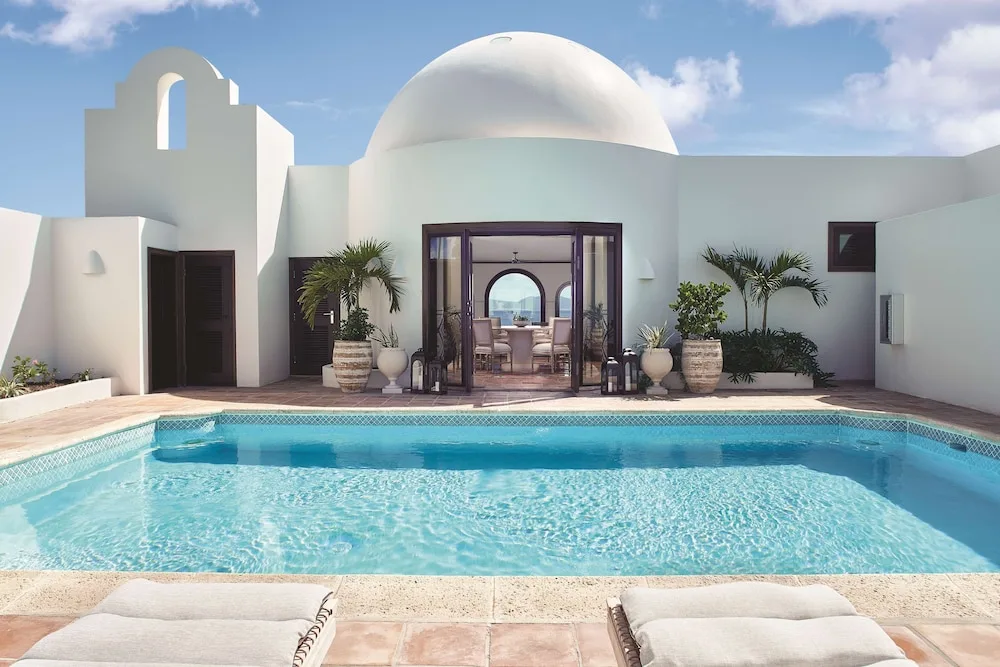 Private pool courtyard with white domed villa exterior at Cap Juluca, Anguilla.