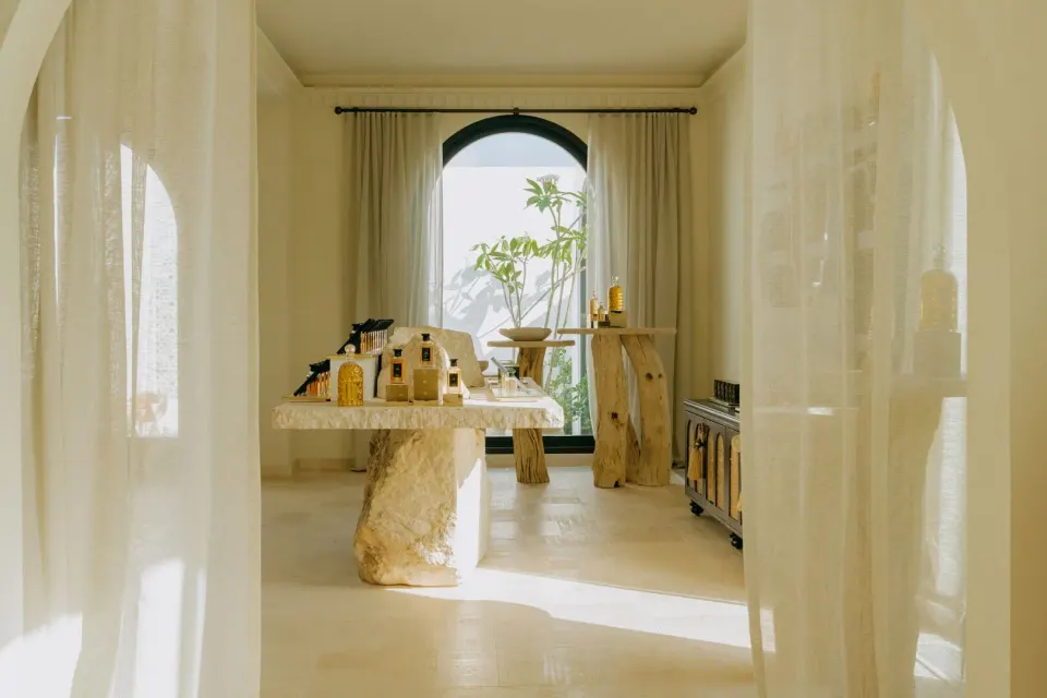Spa retail room with sheer curtains and product displays at Cap Juluca, Anguilla.