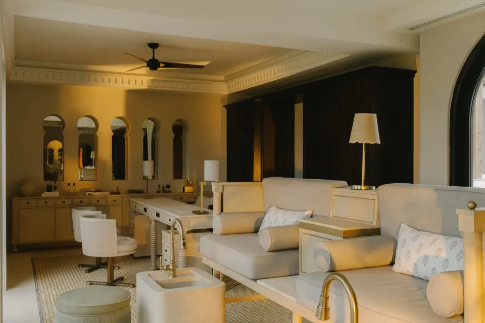 Spa treatment room with cushioned loungers and mirrored vanity at Cap Juluca, Anguilla.