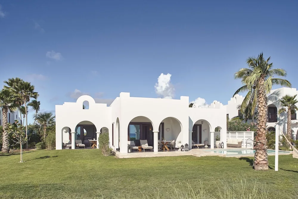 White arched villa buildings and lawn at Cap Juluca, Anguilla.