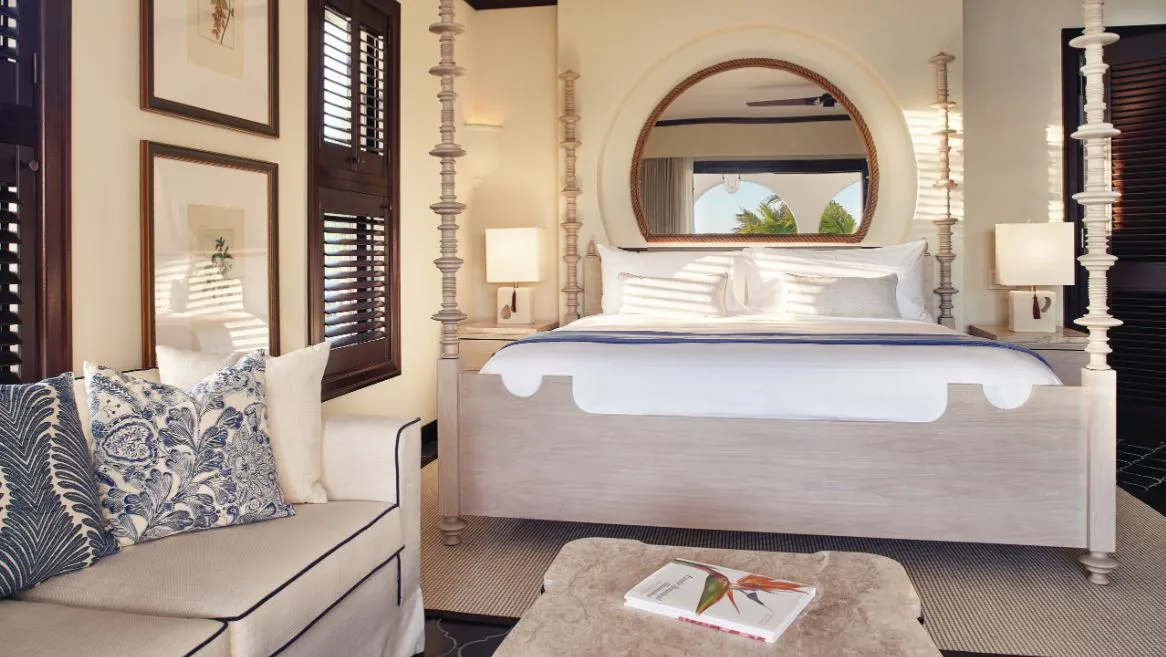 Deluxe Beachfront Room with four-poster bed and sofa at Cap Juluca, Anguilla.