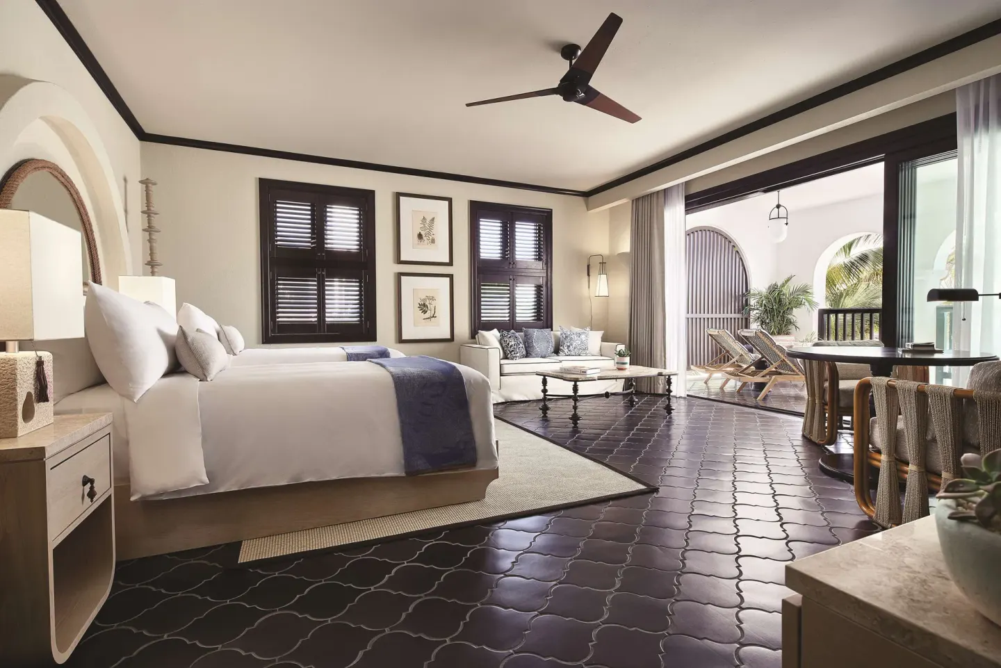 Two twin beds and sitting area in a Junior Suite Beachfront at Cap Juluca, Anguilla.