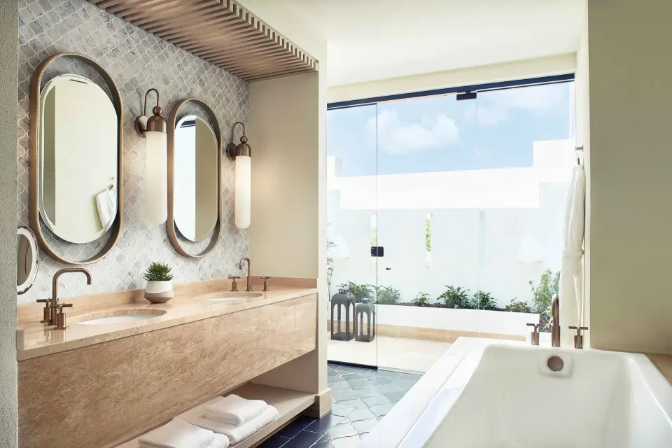 Premium Room Beachfront bathroom with twin vanity and tub at Cap Juluca, Anguilla.