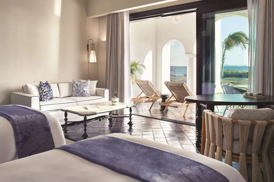 Premium Room Beachfront beds, sofa and patio doors at Cap Juluca, Anguilla.