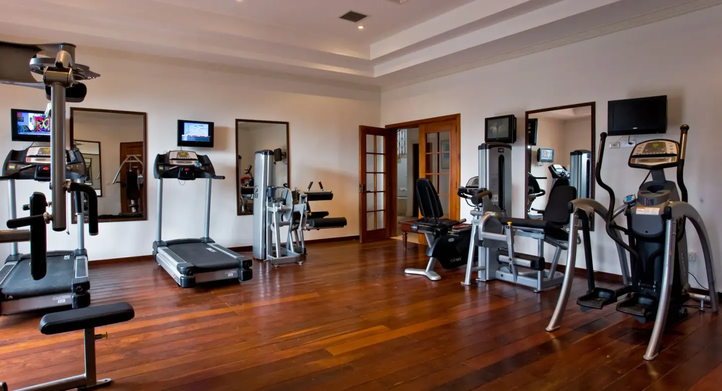 Fitness room with treadmills and cardio machines at Cap Maison Resort & Spa.