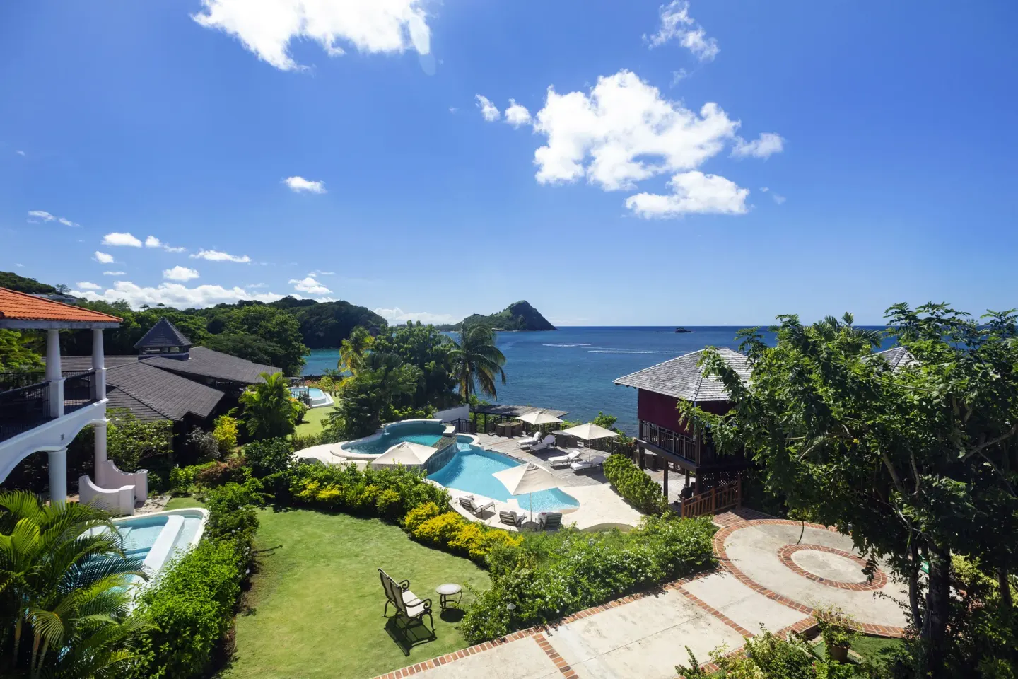 Gardens, pool, and ocean view at Cap Maison Resort & Spa.
