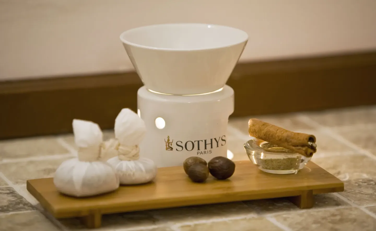 Spa aromatherapy setup with warmer, herbs, and stones at Cap Maison Resort & Spa.