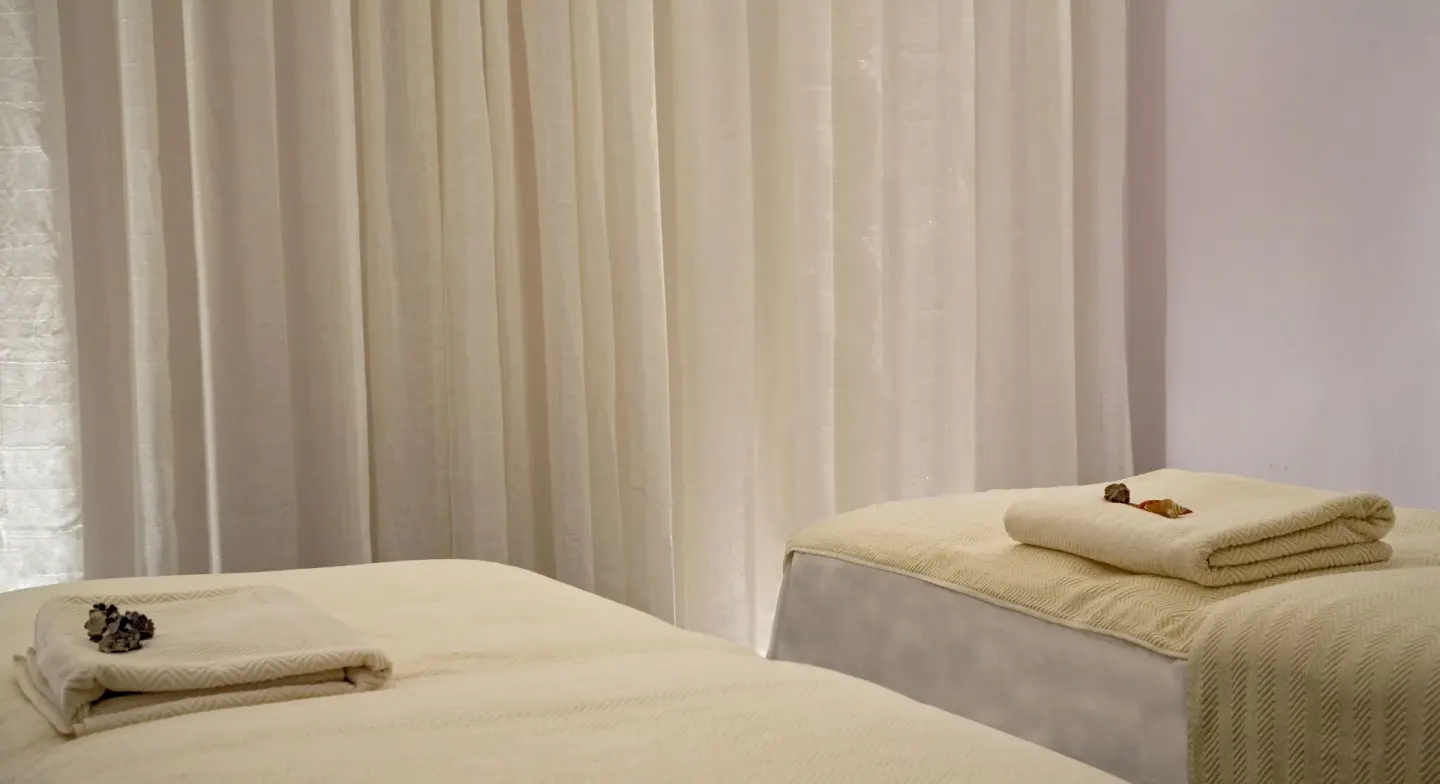 Spa treatment beds with folded towels at Cap Maison Resort & Spa.