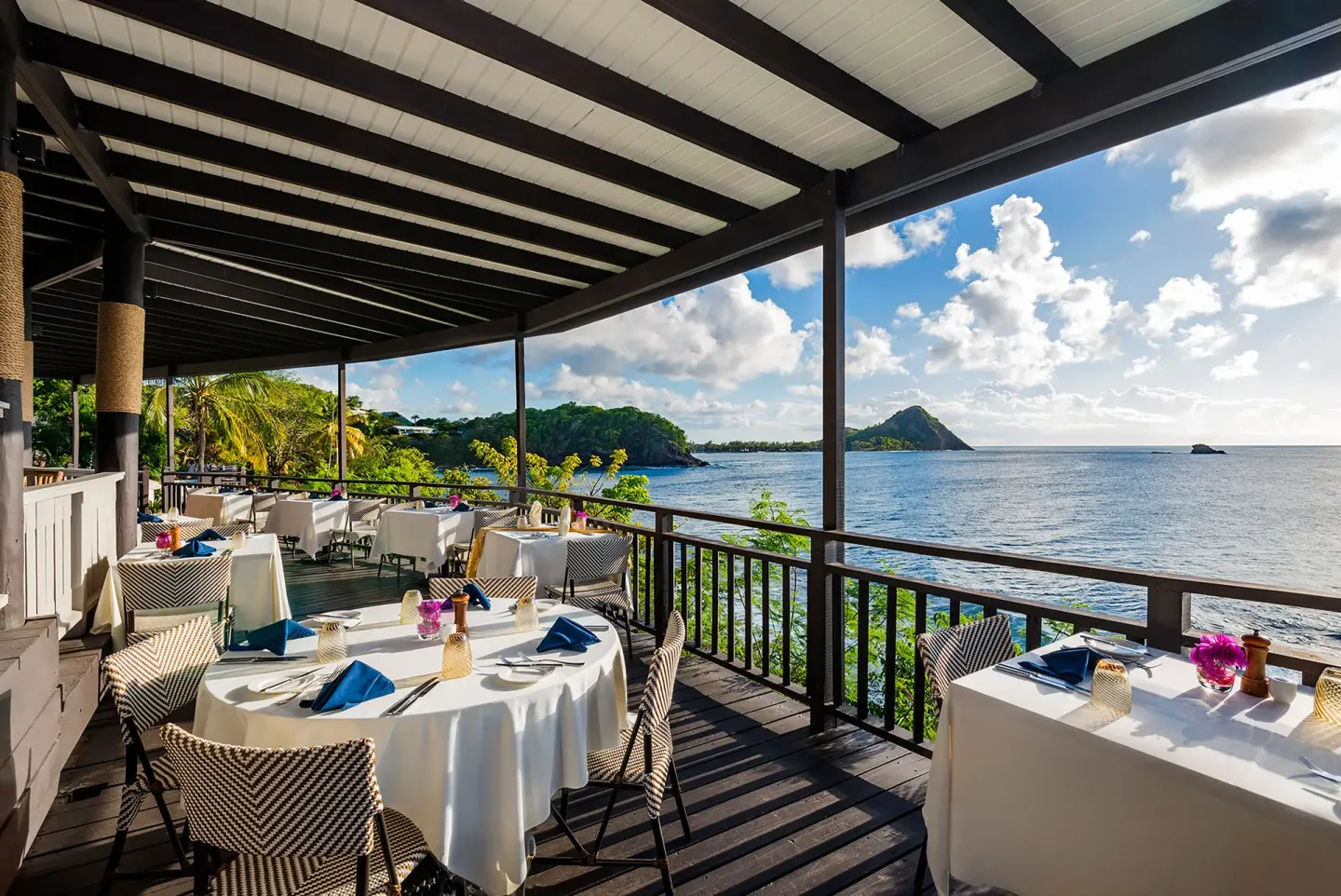 Oceanfront terrace dining with set tables at Cap Maison Resort & Spa.