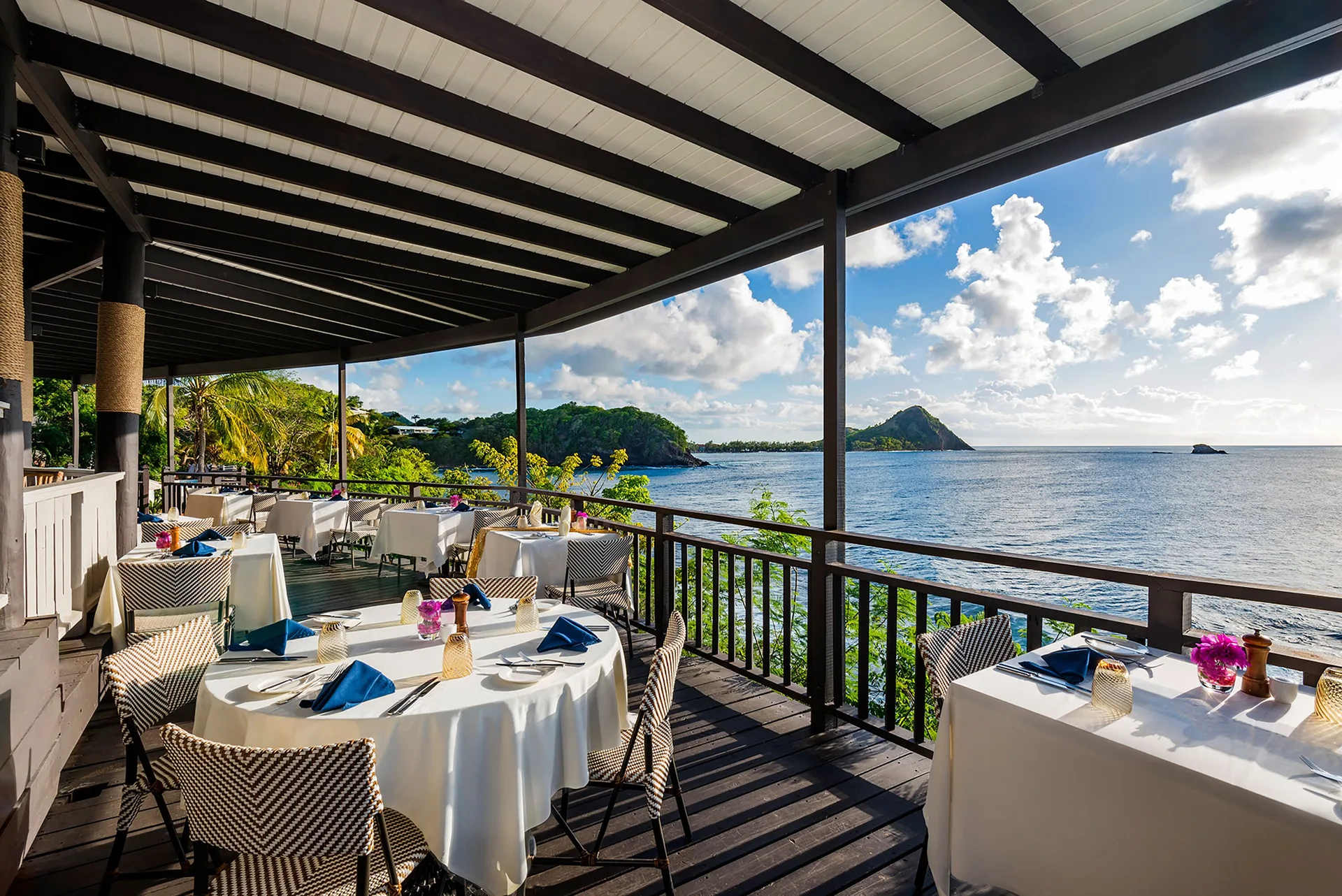 Oceanfront terrace dining with set tables at Cap Maison Resort & Spa.