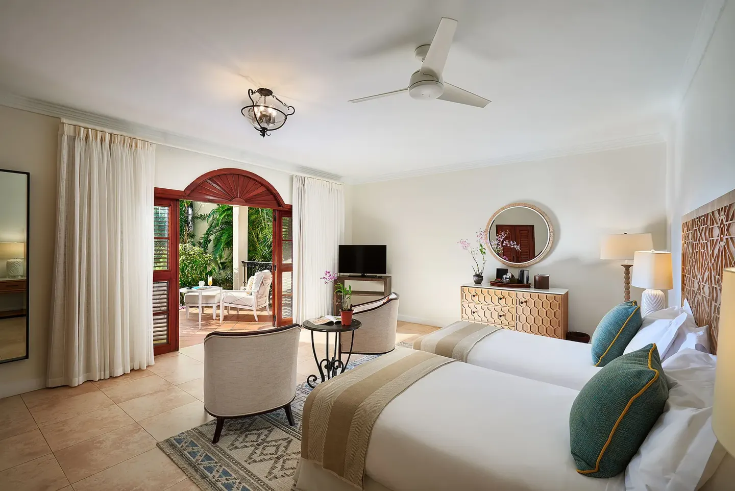 Garden View Room with twin beds and patio doors at Cap Maison Resort & Spa.