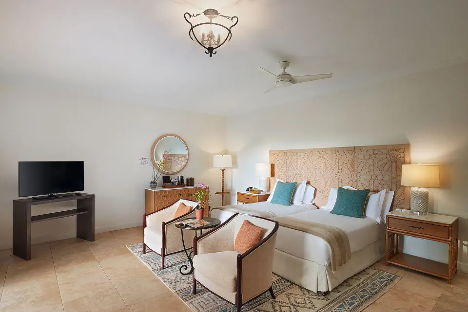 Garden View Room with twin beds and seating area at Cap Maison Resort & Spa.