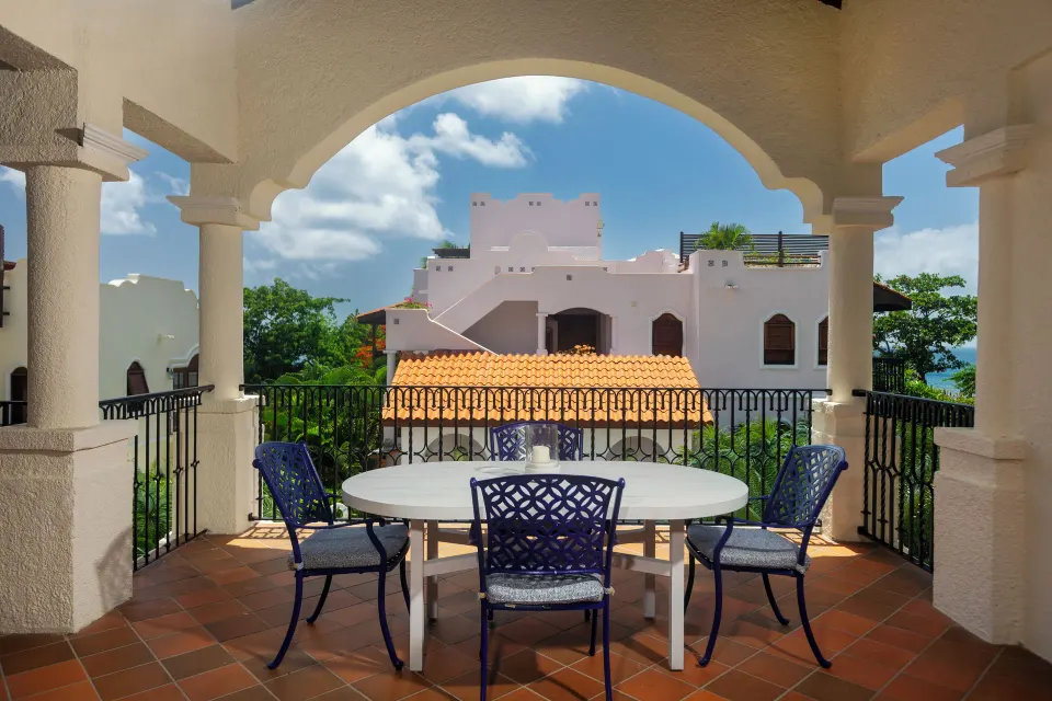 Arched balcony dining area for a Spanish Courtyard suite at Cap Maison Resort & Spa.