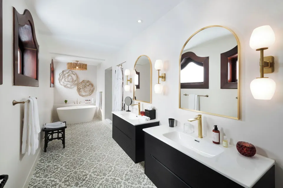 Bathroom with twin vanities and soaking tub at Cap Maison Resort & Spa.