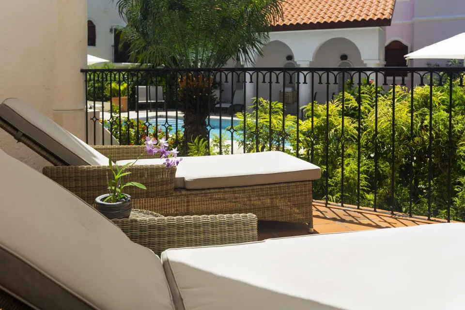 Terrace loungers overlooking the courtyard pool at Cap Maison Resort & Spa.