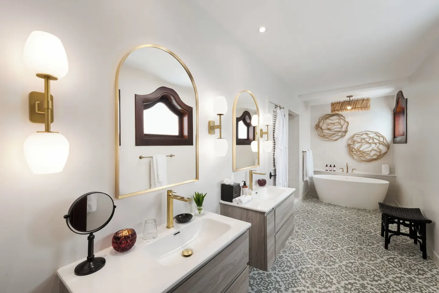 Double vanity, freestanding tub, and patterned tile in a Spanish Courtyard suite at Cap Maison Resort & Spa.