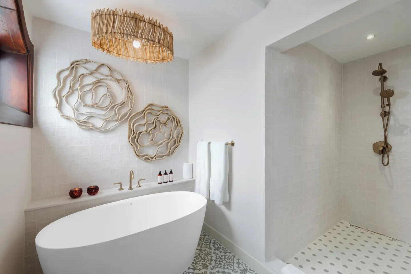 Freestanding tub and walk-in shower in a Spanish Courtyard suite bathroom at Cap Maison Resort & Spa.
