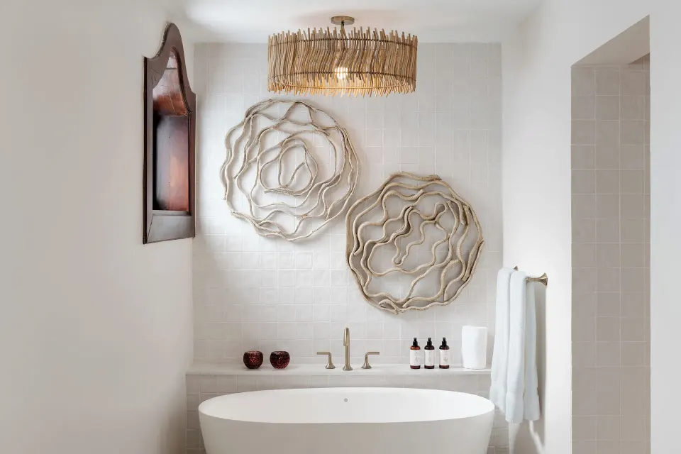 Freestanding bathtub with woven light fixture in a Spanish Courtyard suite at Cap Maison Resort & Spa.