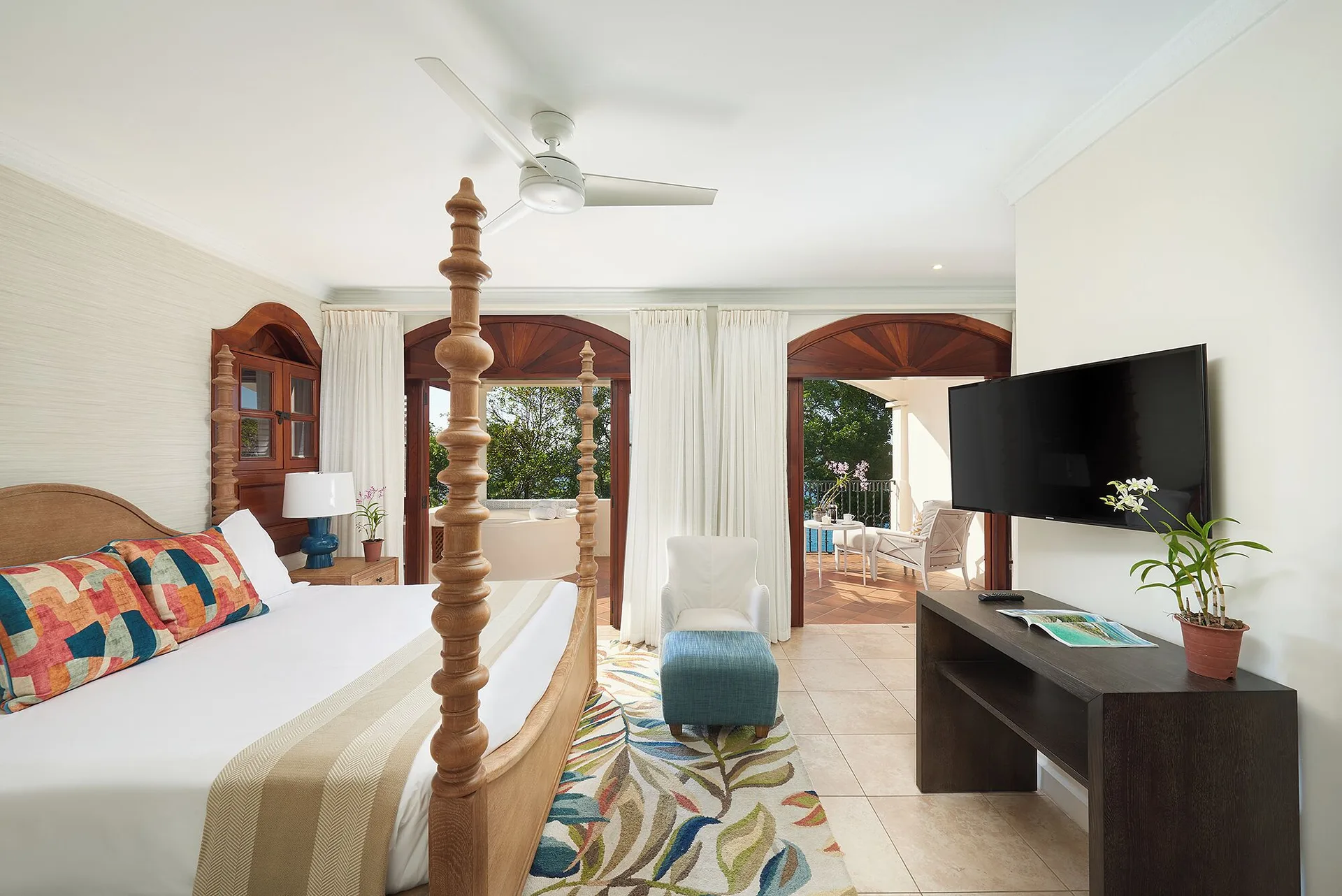 Ocean View Suite bedroom with four-poster bed and balcony at Cap Maison Resort & Spa.