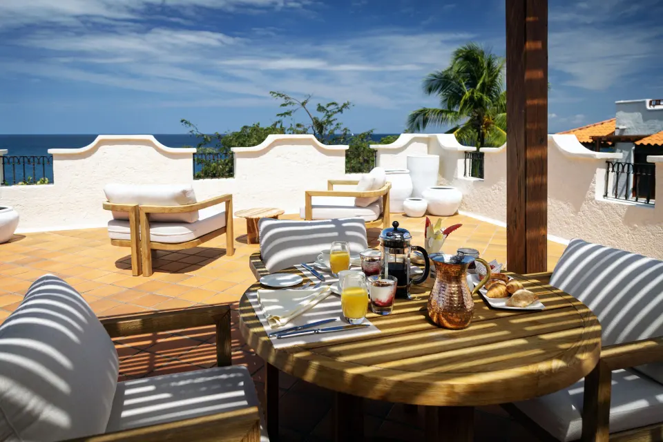 Breakfast table on the villa terrace with ocean views at Cap Maison Resort & Spa.