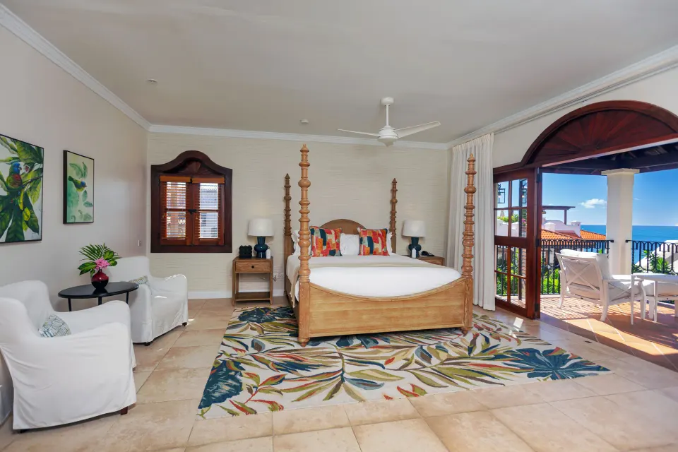 Four-poster bed in an ocean view villa bedroom at Cap Maison Resort & Spa.