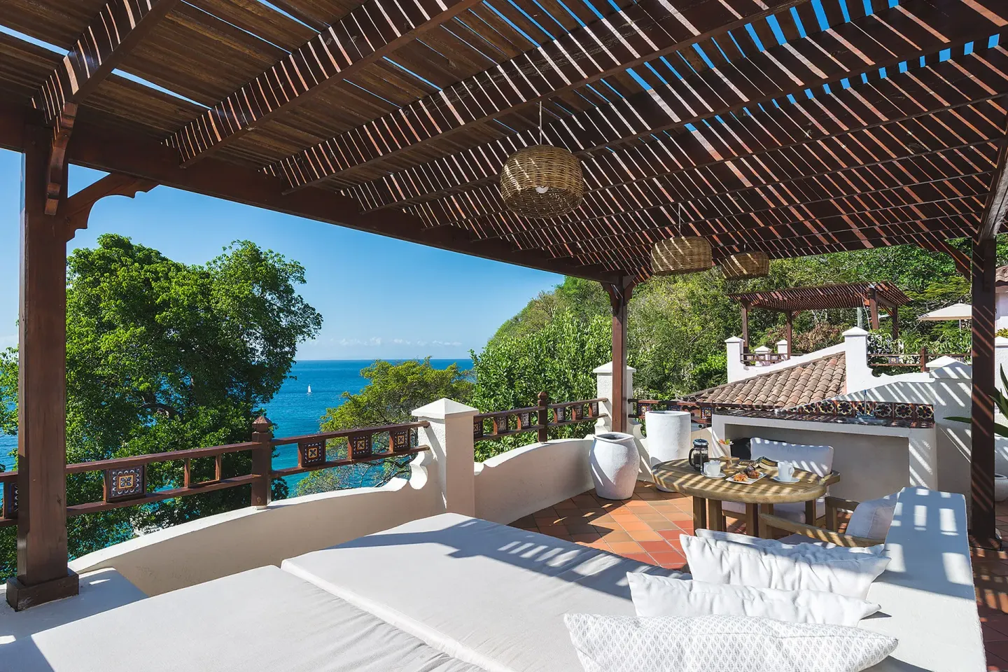 Shaded roof terrace daybed with Caribbean Sea view at Cap Maison Resort & Spa.