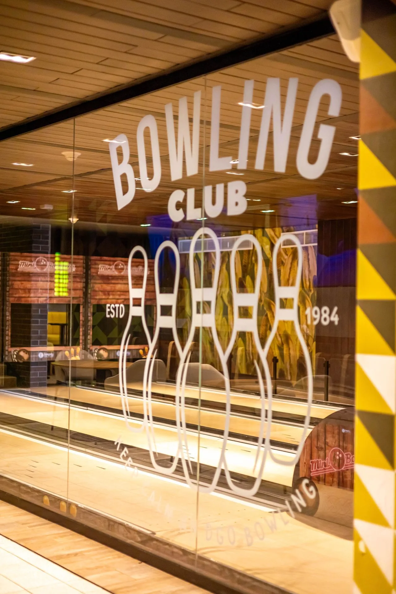 Glass doors marked bowling club reveal indoor lanes at Caribe Deluxe Princess.
