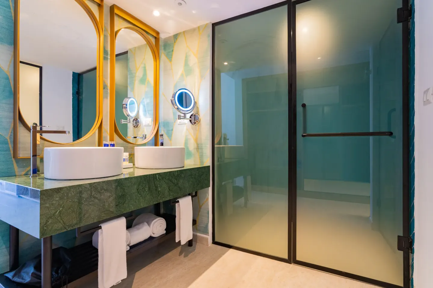 Guest bathroom with double sinks and glass shower at Caribe Deluxe Princess.