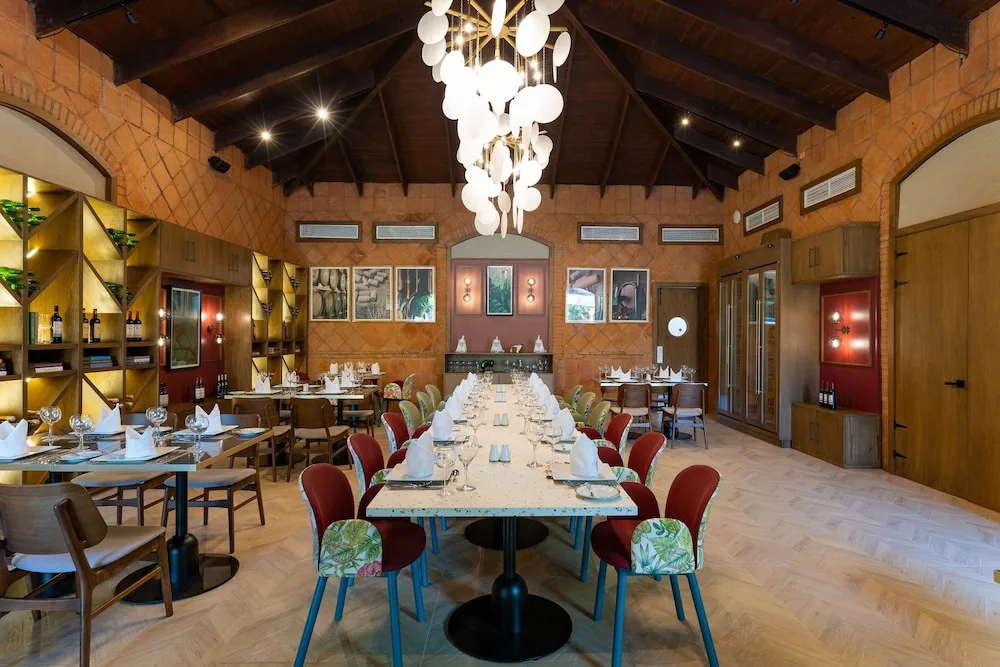 Gourmet dining room with wine shelving and a long table at Caribe Deluxe Princess.