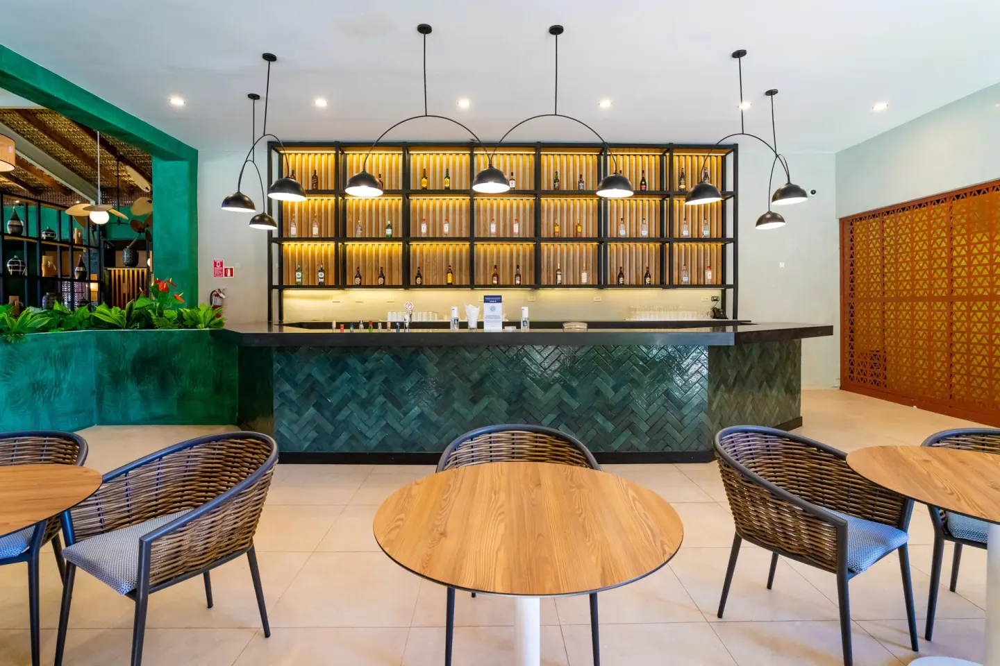 Lobby bar with green tile counter and bottle shelves at Caribe Deluxe Princess.