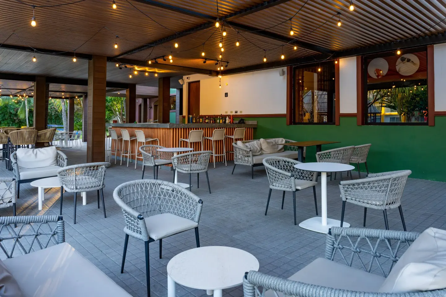 Covered open-air bar terrace with wicker seating at Caribe Deluxe Princess.