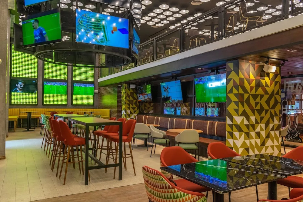 Sports bar seating area with many televisions at Caribe Deluxe Princess.