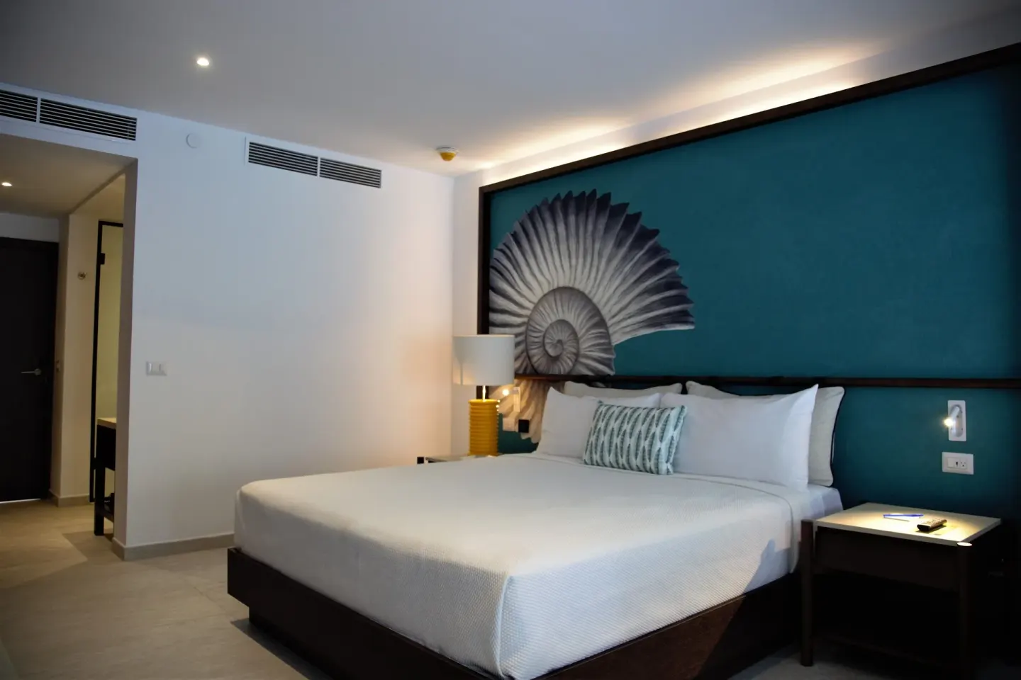Grand Room king bed facing entry area at Caribe Deluxe Princess.