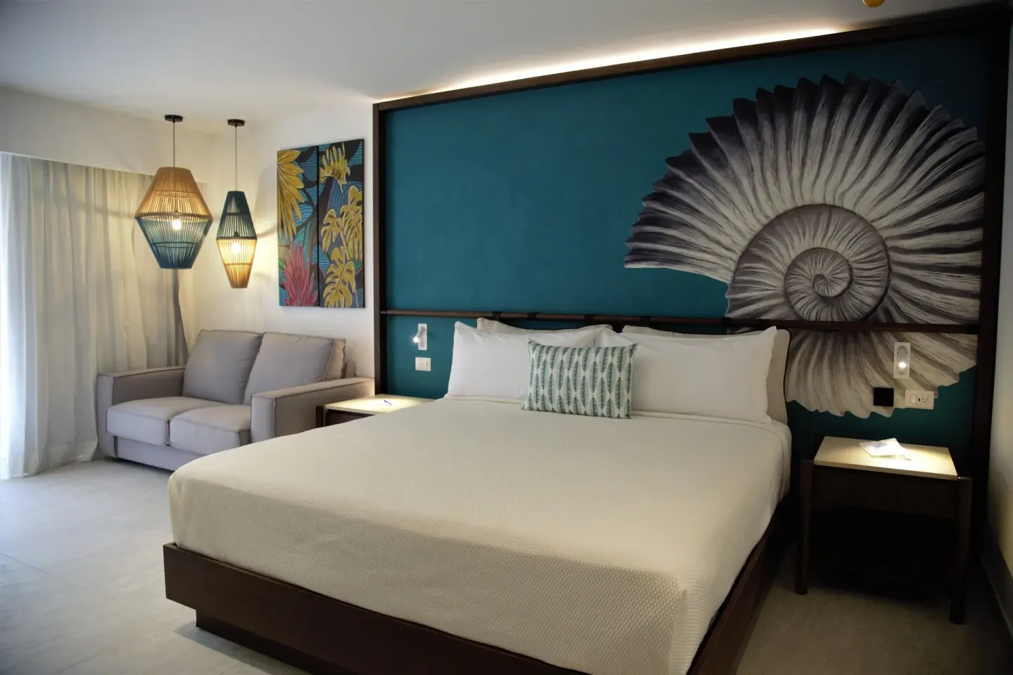 Grand Room king bed and sofa seating at Caribe Deluxe Princess.