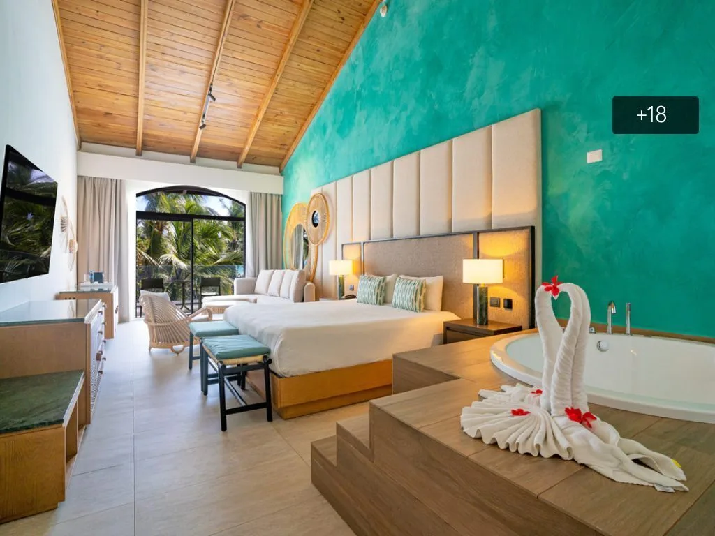 De Luxe guest room with king bed and in-room whirlpool tub at Caribe Deluxe Princess.