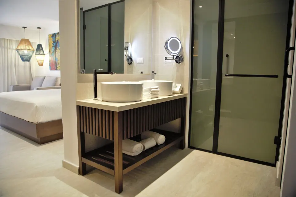 Superior Room bathroom vanity and bed area at Caribe Deluxe Princess.