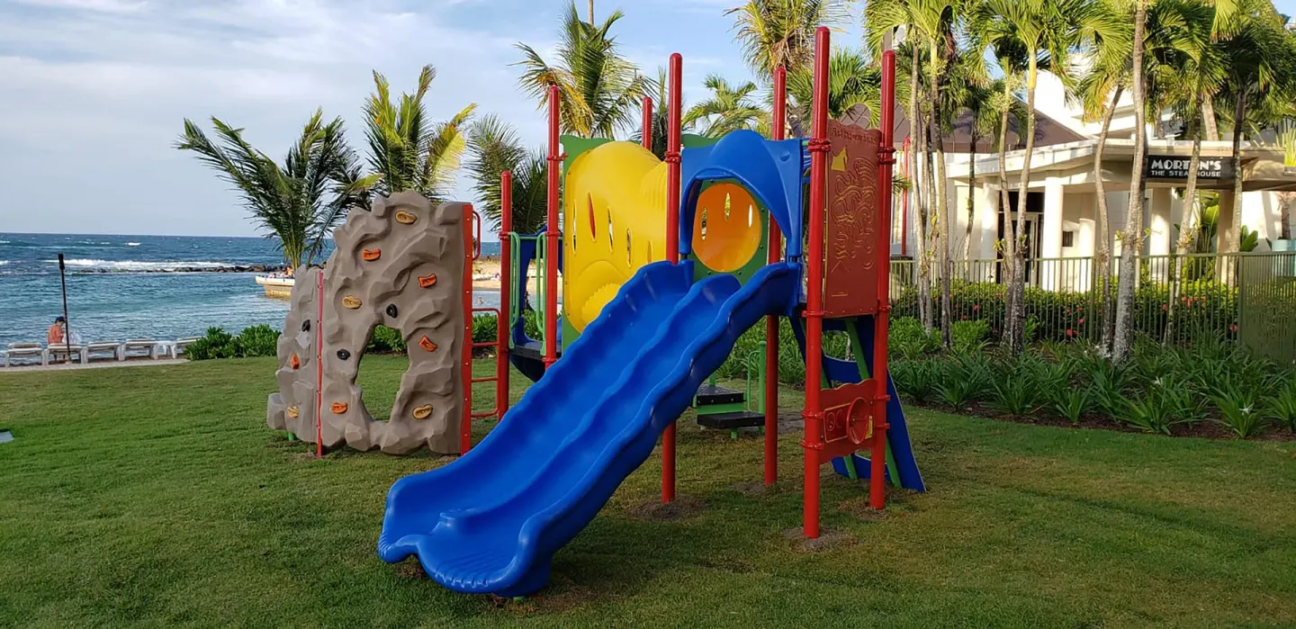 Colorful children's playground beside the ocean at Caribe Hilton.