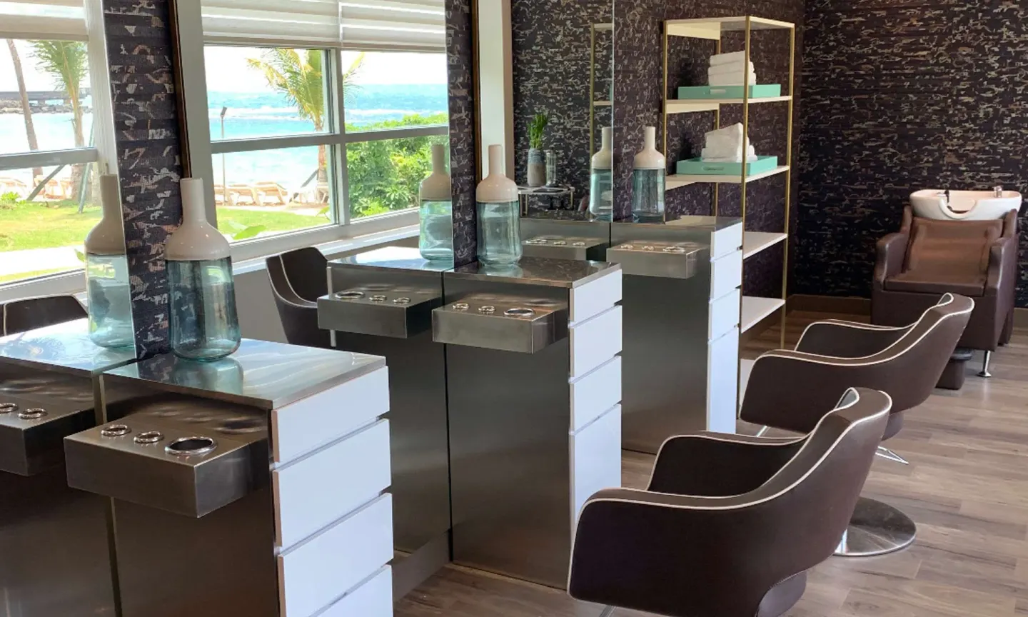 Salon styling stations with ocean-facing windows at Caribe Hilton.
