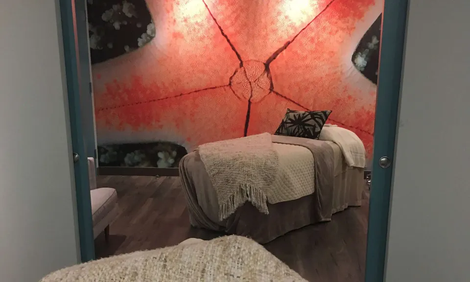 Spa treatment room with starfish wall mural at Caribe Hilton.