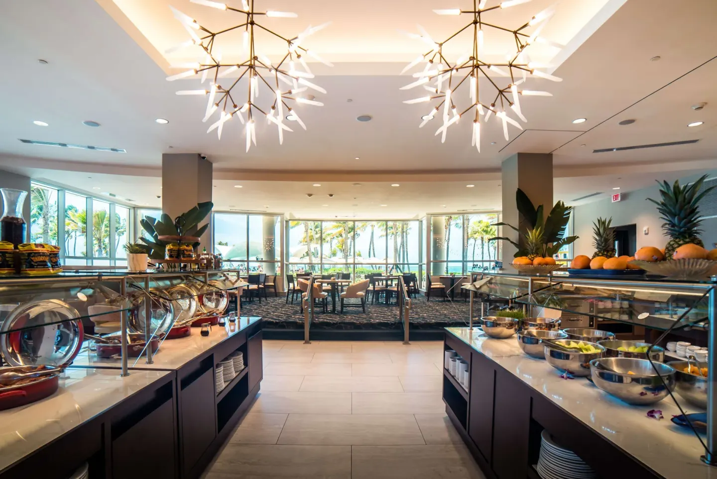 Breakfast buffet with fruit and dining tables at Caribe Hilton.