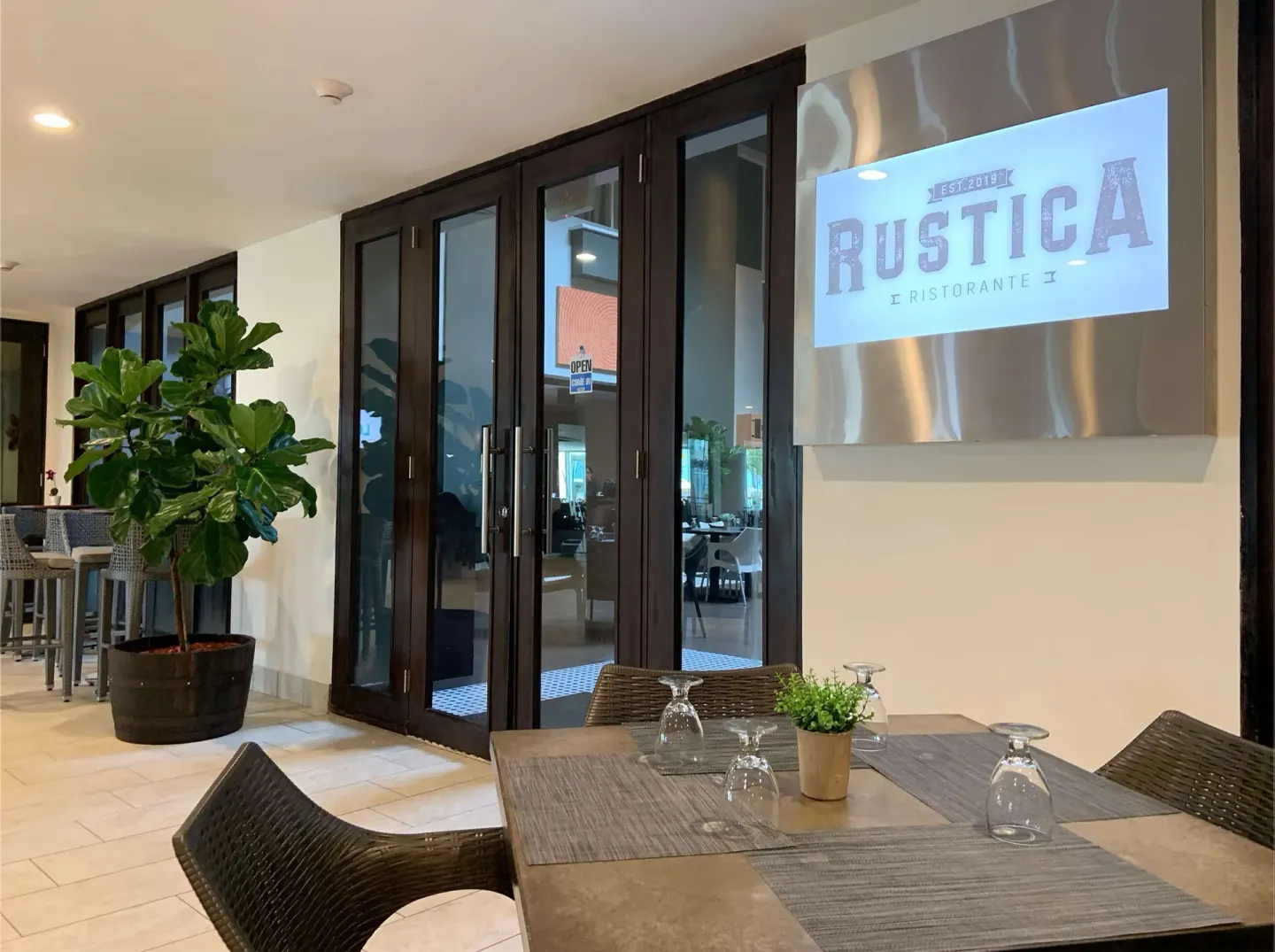 Rustica Ristorante entrance and patio table at Caribe Hilton.