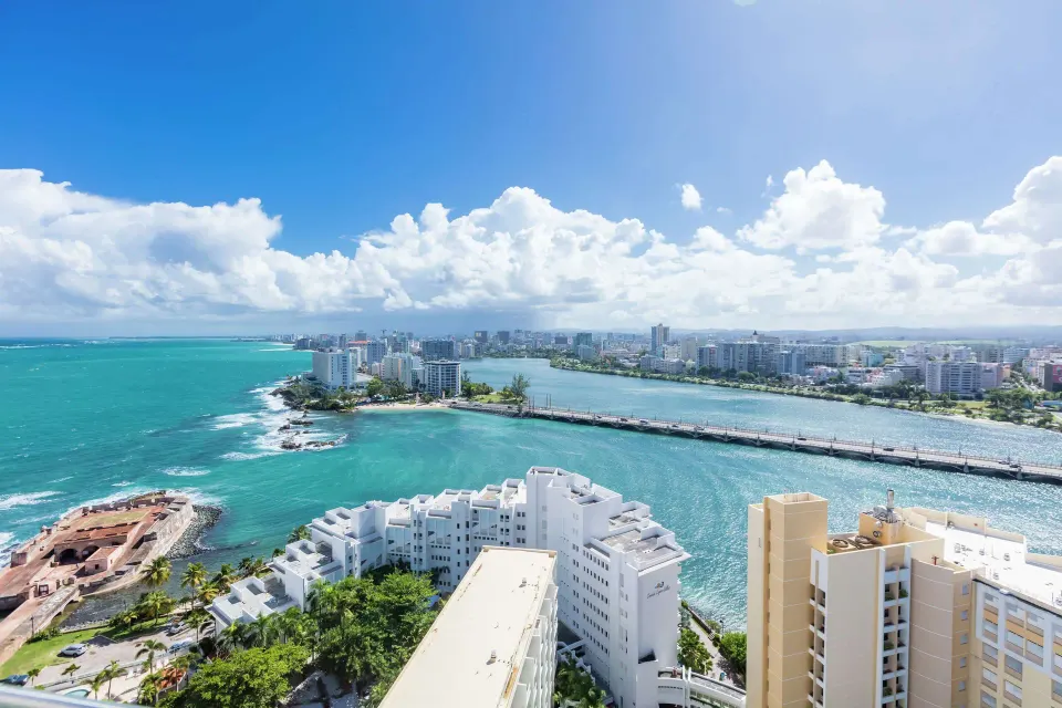 Panoramic lagoon and ocean view from a two-bedroom bi-level suite at Caribe Hilton above San Juan.