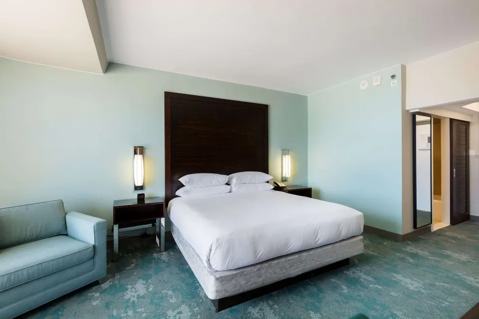 King guest room with sofa and bathroom entry at Caribe Hilton.