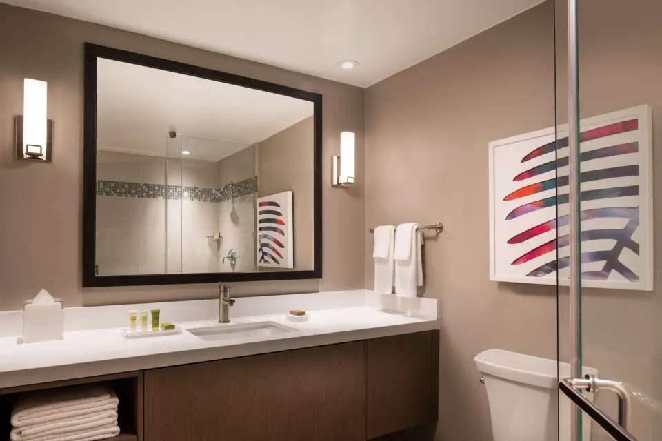 Premium Garden View guest room bathroom vanity and shower at Caribe Hilton.