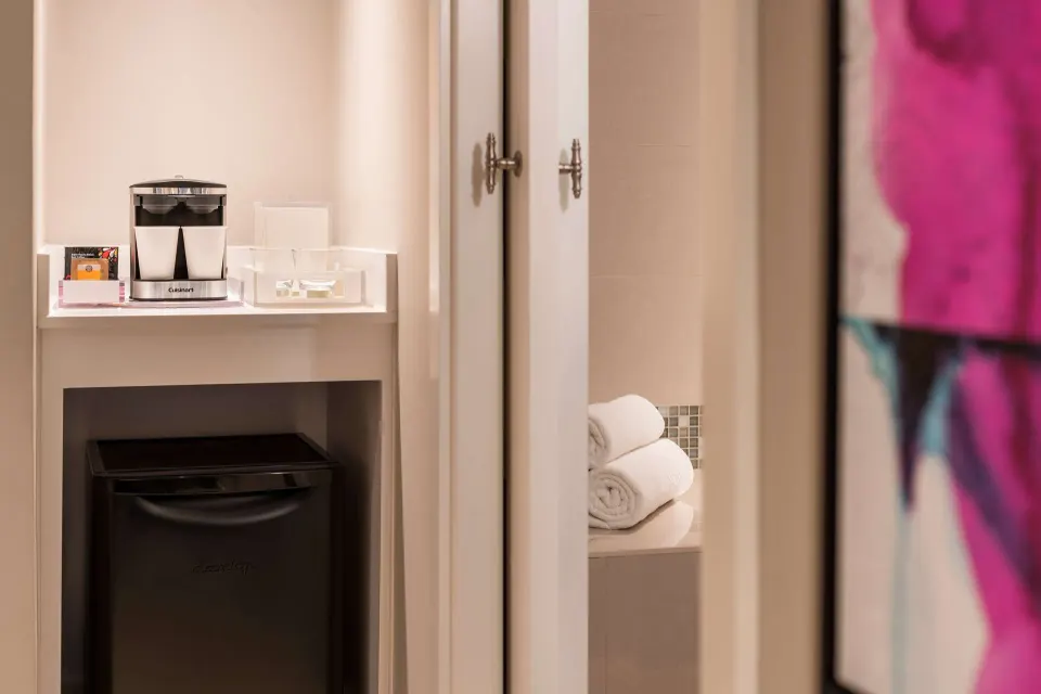 Premium Garden View room coffee nook and mini refrigerator at Caribe Hilton.