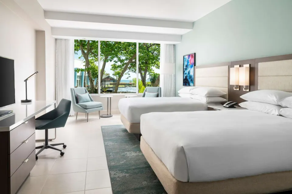 Premium Garden View room with two beds and garden-facing window at Caribe Hilton.