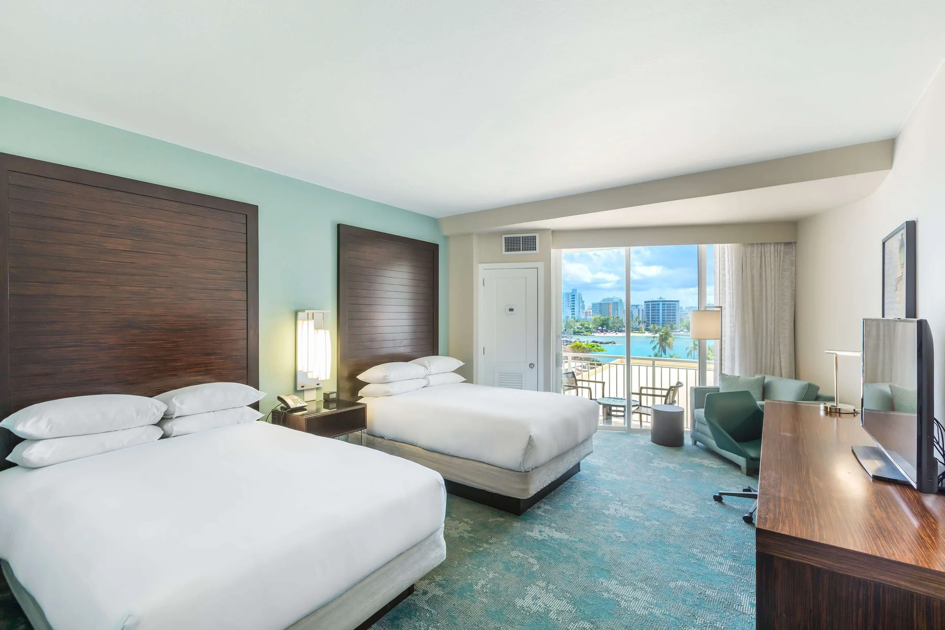 Caribe Room Resort or Garden View at Caribe Hilton with two double beds, private balcony, and tropical garden or resort views in San Juan.