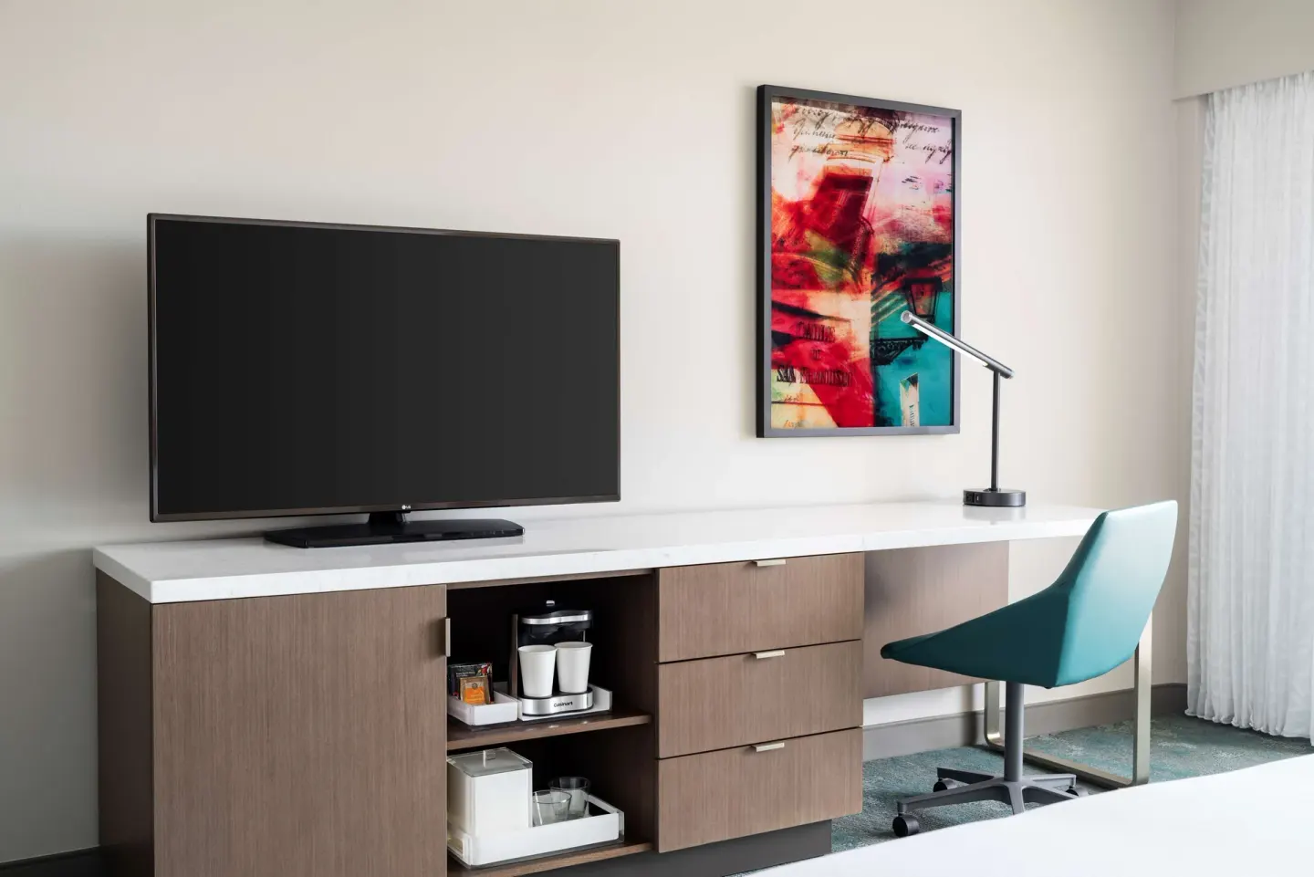 Guest room desk, TV, chair, and coffee station at Caribe Hilton.